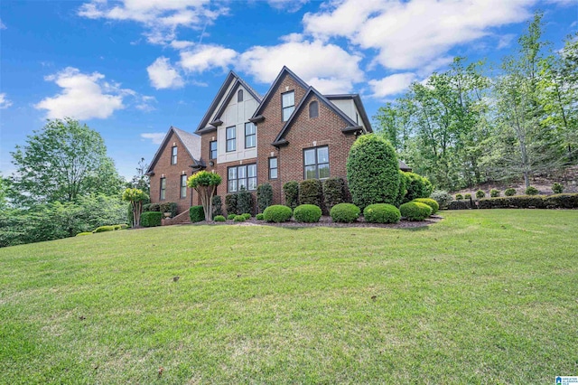 view of front of property with brick siding and a front yard