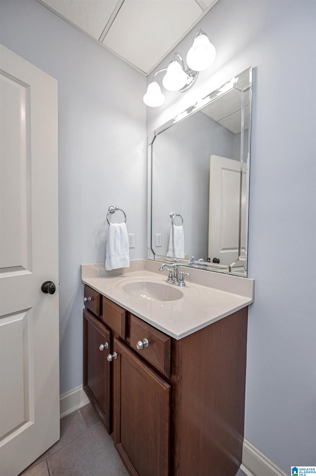 bathroom featuring vanity, tile patterned flooring, and baseboards