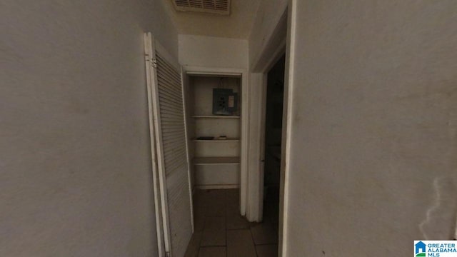 hall featuring visible vents and tile patterned flooring