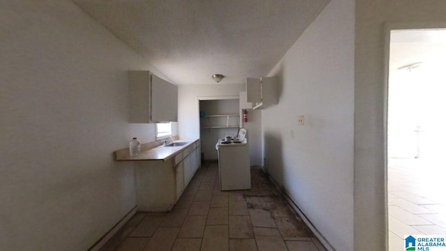 kitchen featuring light countertops, white range with electric stovetop, and a sink