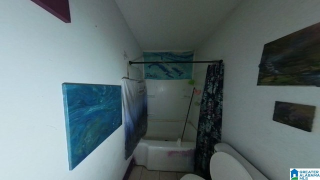 full bath with tile patterned flooring, shower / bathing tub combination, and toilet