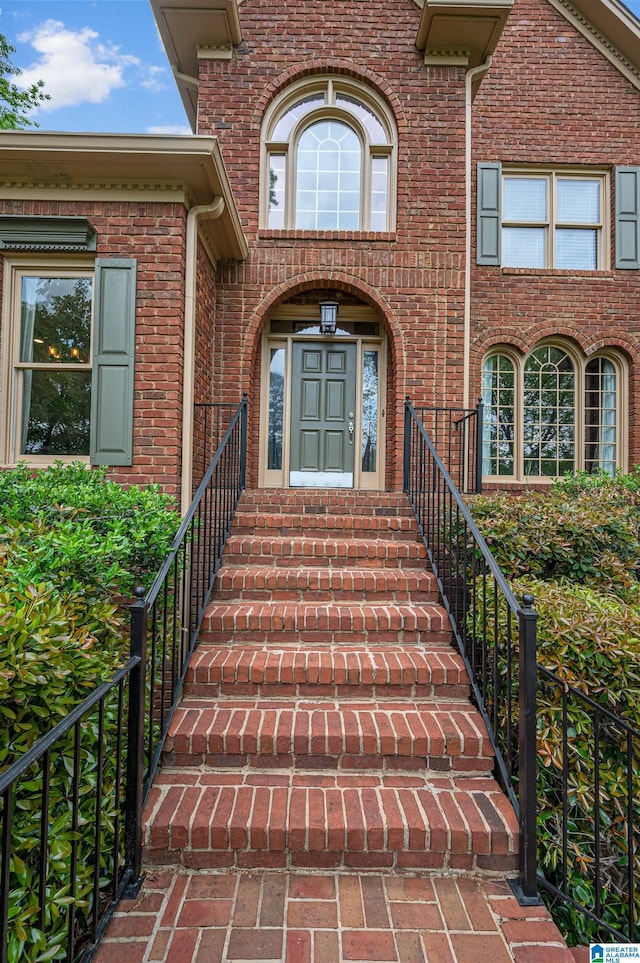 doorway to property featuring brick siding
