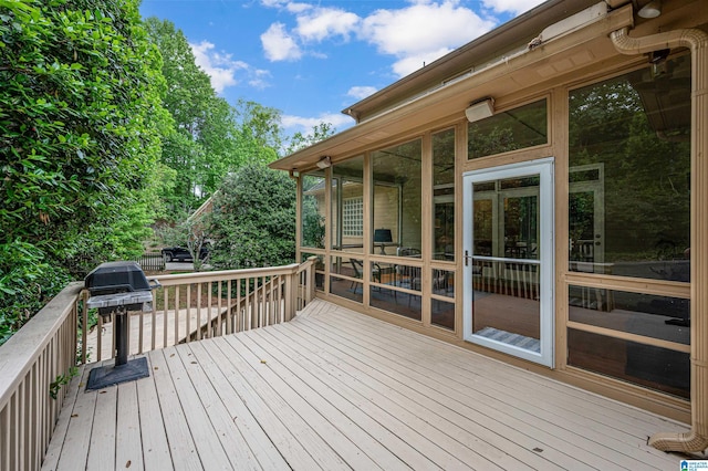 deck with area for grilling and a sunroom