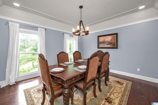 dining space featuring a chandelier, baseboards, visible vents, a raised ceiling, and dark wood-type flooring