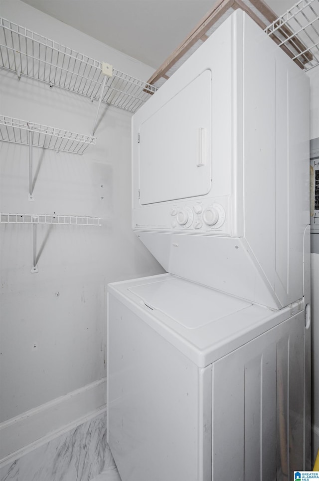 113 N 22nd St Unit 403, Birmingham, AL 35203 - laundry area featuring stacked washer and clothes dryer and light marble finish floors