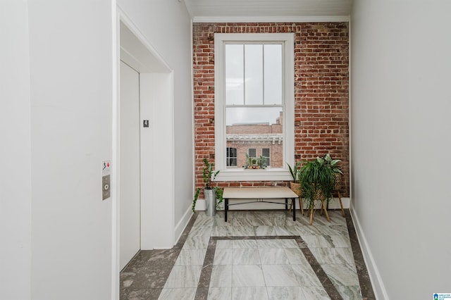 113 N 22nd St Unit 403, Birmingham, AL 35203 - hallway with inlaid floor details, marble tiled flooring, and brick wall