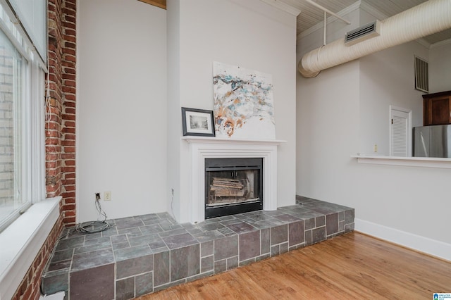 113 N 22nd St Unit 403, Birmingham, AL 35203 - unfurnished living room featuring wood finished floors and a fireplace with raised hearth