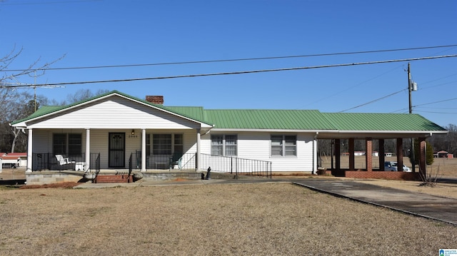 view of front facade with a chimney, a porch, and metal roof