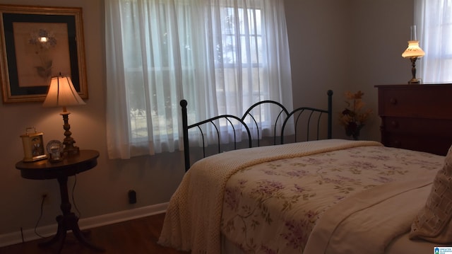 bedroom with wood finished floors and baseboards