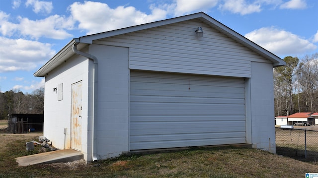 detached garage featuring fence