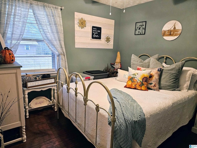 bedroom with dark wood finished floors