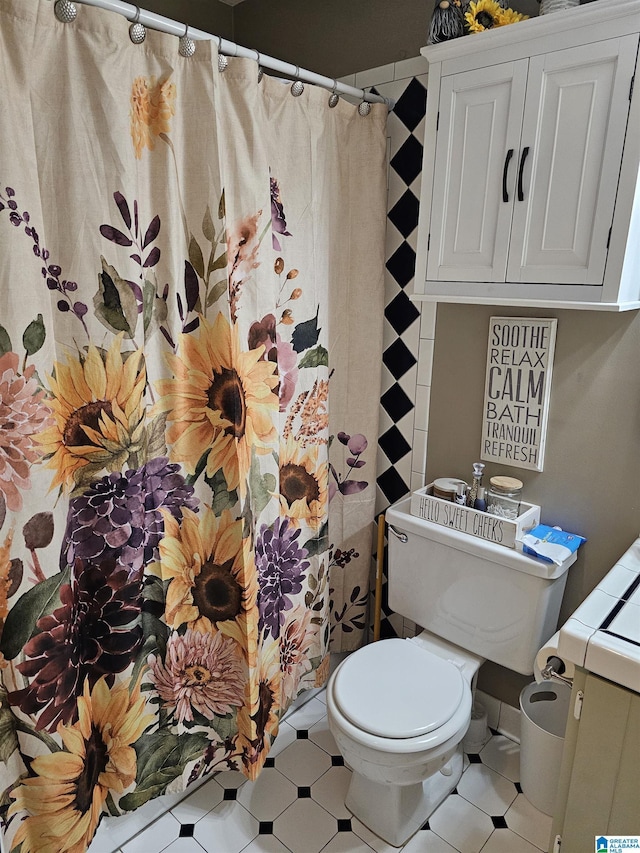 bathroom with curtained shower and toilet