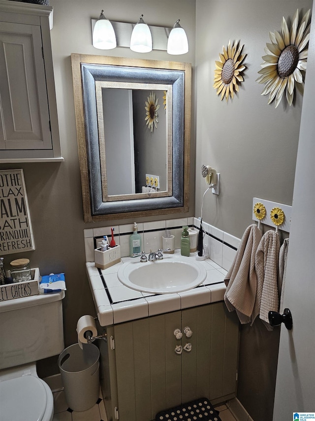 half bath featuring toilet and vanity