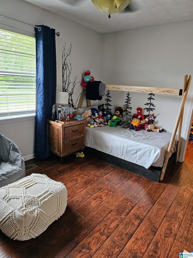bedroom with hardwood / wood-style flooring and ceiling fan