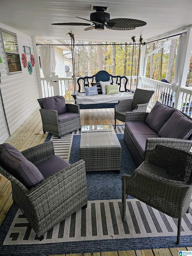 sunroom featuring ceiling fan and an outdoor hangout area