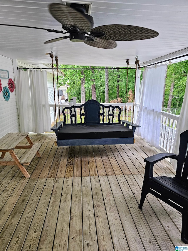wooden deck with a ceiling fan