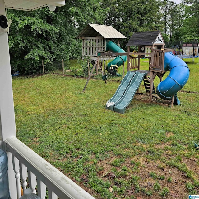 view of playground featuring a trampoline and a lawn