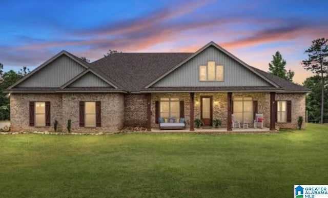 rear view of house featuring a lawn