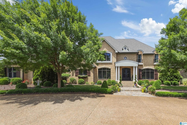 view of front of property featuring brick siding and french doors
