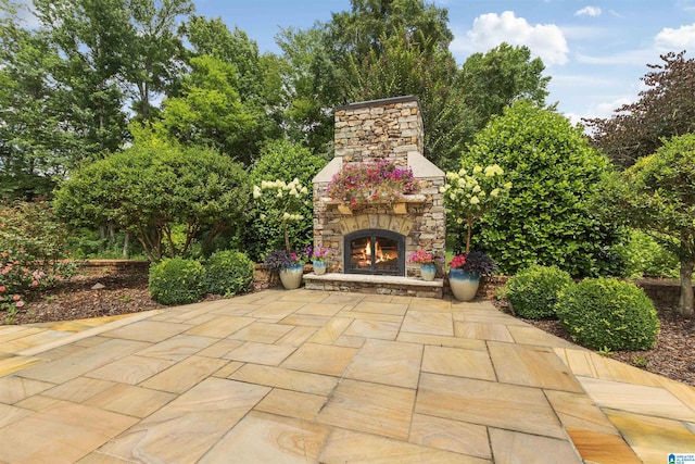 view of patio featuring an outdoor stone fireplace