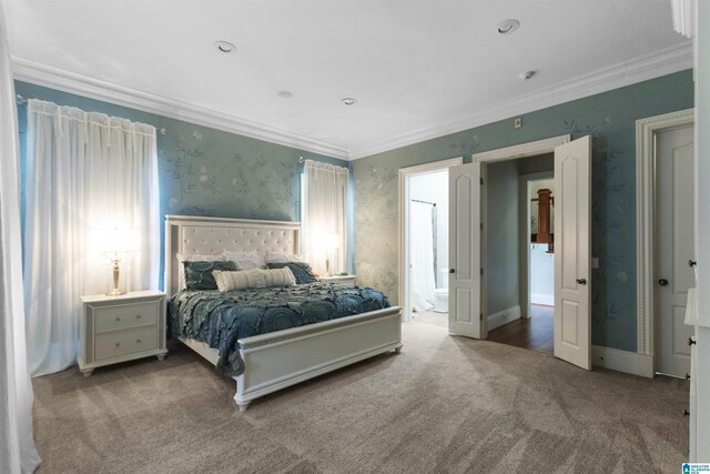 bedroom with wallpapered walls, carpet flooring, crown molding, and ensuite bathroom