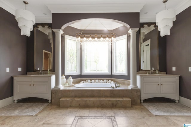 bathroom featuring crown molding, a sink, and decorative columns