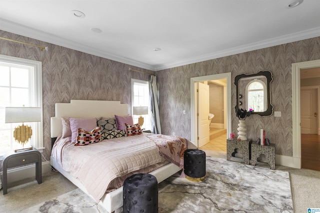 carpeted bedroom with wallpapered walls, ensuite bath, crown molding, and baseboards