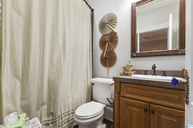 bathroom with toilet, vanity, and curtained shower