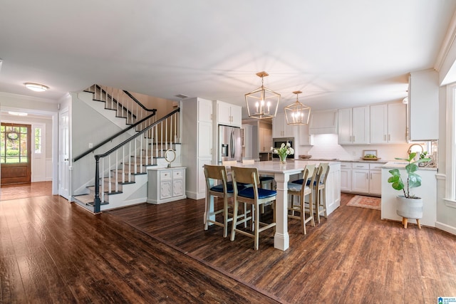 kitchen featuring white cabinets, a chandelier, light countertops, dark wood finished floors, and stainless steel fridge with ice dispenser