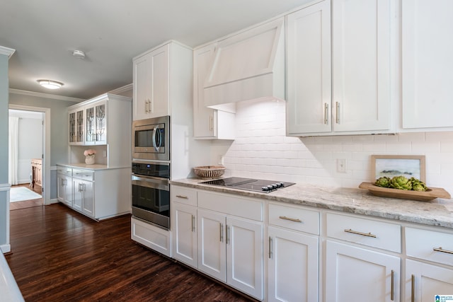 kitchen featuring decorative backsplash, stainless steel appliances, ornamental molding, white cabinetry, and dark wood-style floors