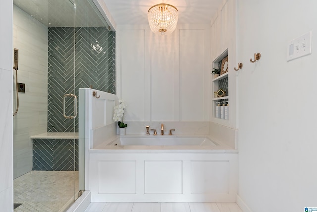 full bath with an inviting chandelier and a stall shower