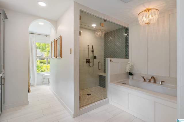 bathroom featuring a stall shower, recessed lighting, an inviting chandelier, and baseboards