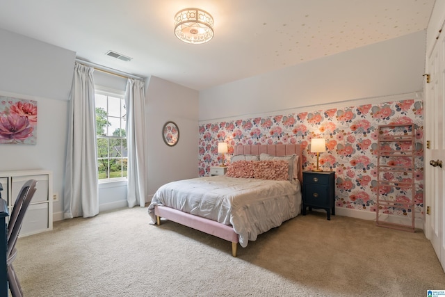 bedroom with baseboards, visible vents, and carpet floors