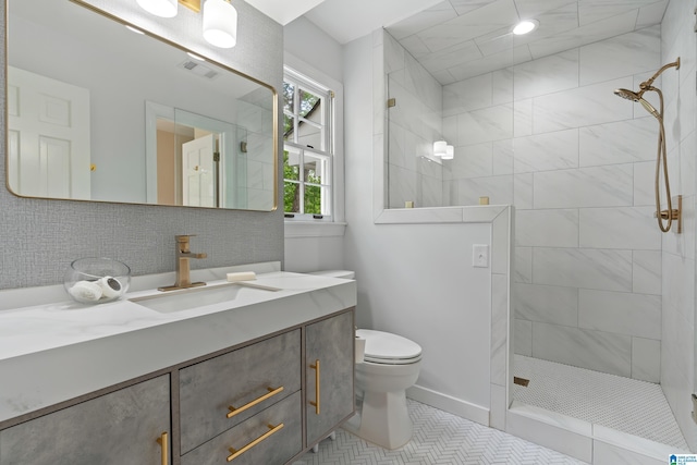 bathroom featuring vanity, tile patterned floors, toilet, visible vents, and walk in shower