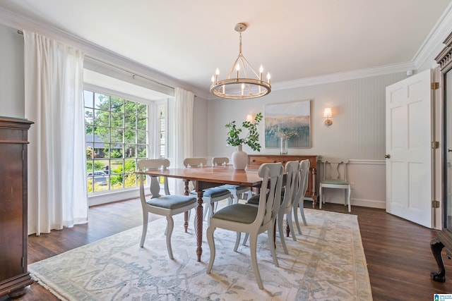 dining space with ornamental molding, baseboards, a chandelier, and dark wood-type flooring