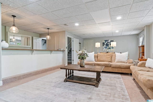 carpeted living room with recessed lighting and stairway