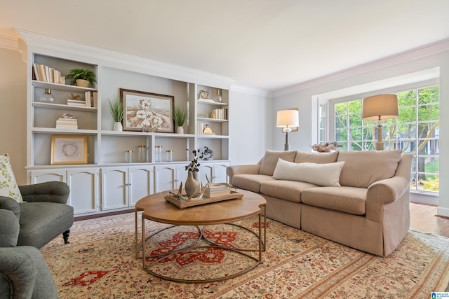 living area featuring ornamental molding, built in features, and wood finished floors