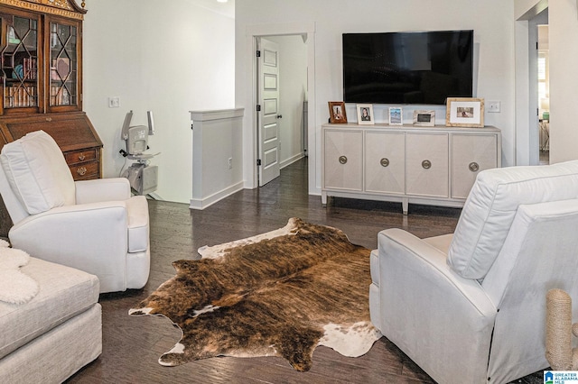 living area featuring baseboards and wood finished floors