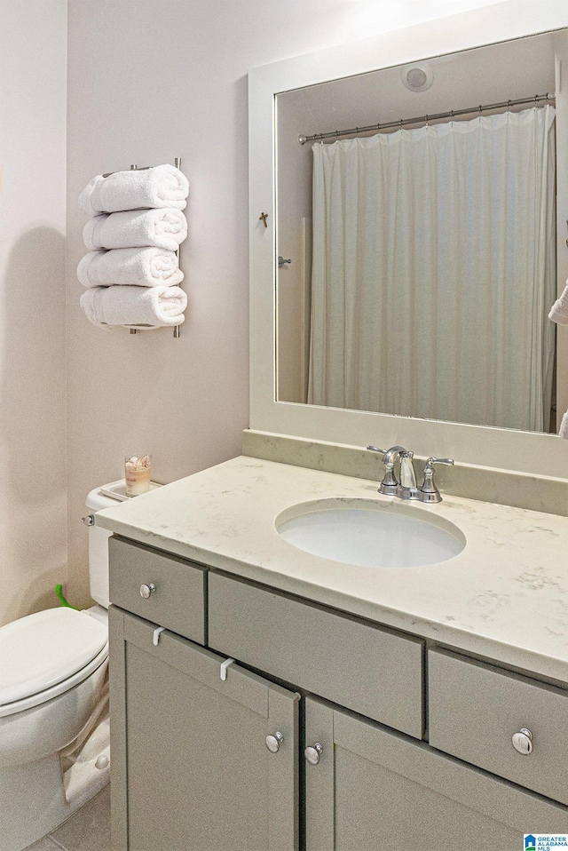 bathroom featuring toilet and vanity
