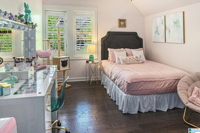 bedroom featuring lofted ceiling, dark wood-type flooring, and baseboards