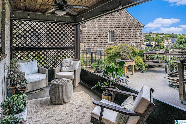 view of patio / terrace with fence and a ceiling fan