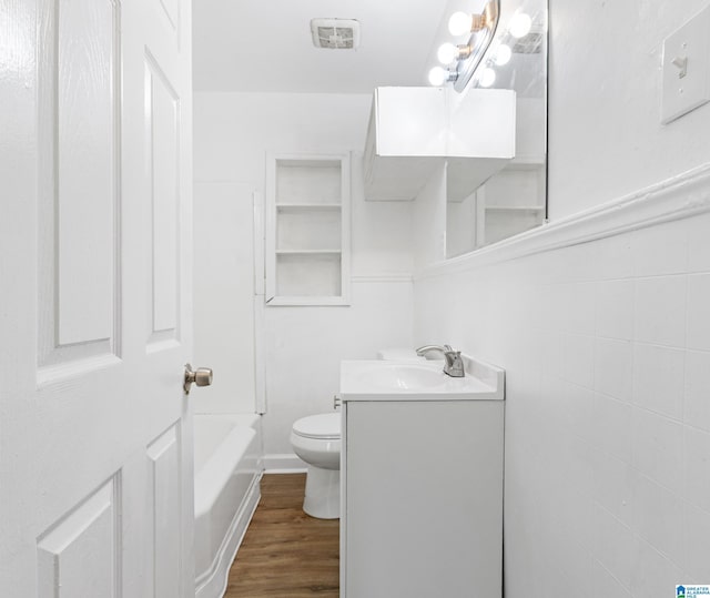 bathroom with vanity, toilet, and wood finished floors