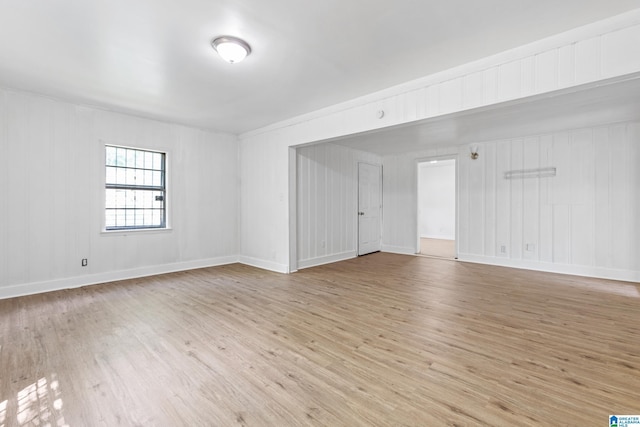 empty room with light wood-type flooring and baseboards