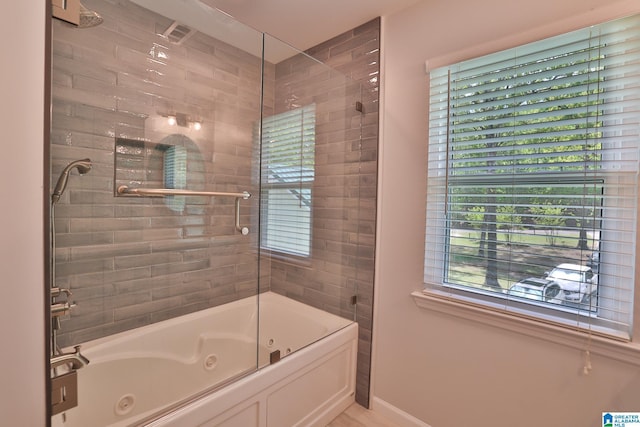 full bath with baseboards and a combined bath / shower with jetted tub
