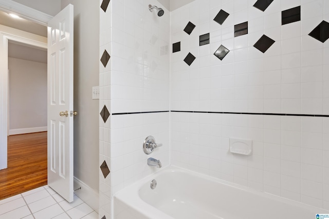 bathroom with tub / shower combination, tile patterned floors, and baseboards