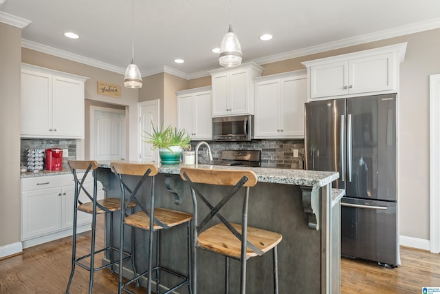 kitchen featuring white cabinets, recessed lighting, stainless steel appliances, light wood-type flooring, and decorative backsplash