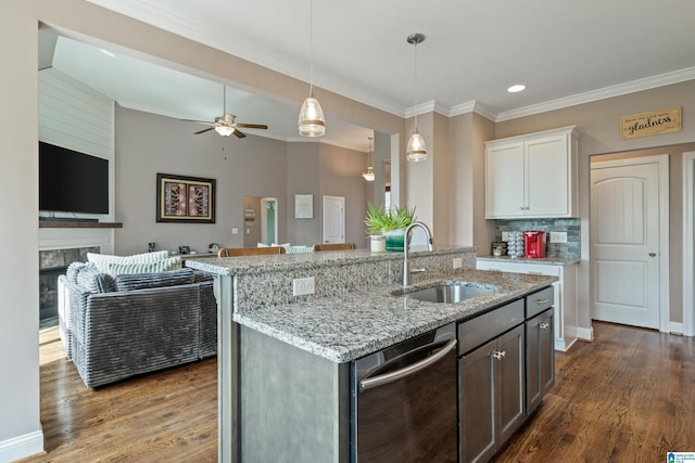 kitchen with dark wood-style floors, dishwasher, a sink, crown molding, and open floor plan