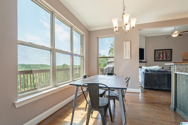 dining space with ceiling fan with notable chandelier, baseboards, ornamental molding, and dark wood finished floors