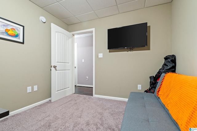 sitting room featuring a paneled ceiling, baseboards, and carpet