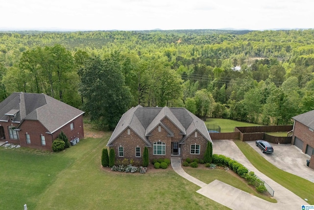 birds eye view of property with a wooded view